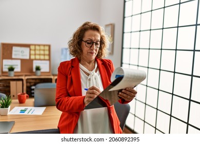 Middle Age Caucasian Businesswoman With Serious Expression Working At The Office.