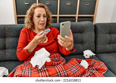 Middle Age Caucasian Illness Woman Having Medical Video Call Sitting On The Sofa At Home.