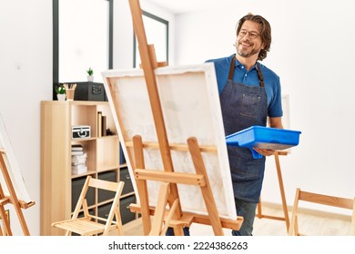 Middle age caucasian man smiling confident drawing at art studio - Powered by Shutterstock