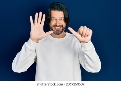 Middle age caucasian man wearing casual clothes showing and pointing up with fingers number six while smiling confident and happy.  - Shutterstock ID 2069253509