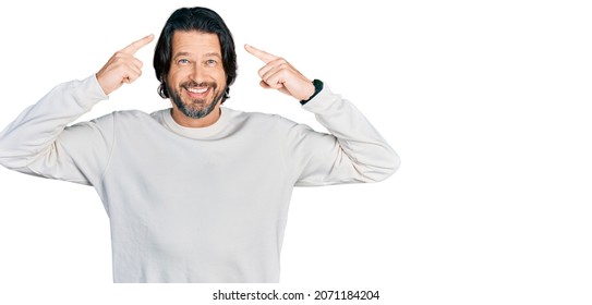 Middle age caucasian man wearing casual clothes smiling pointing to head with both hands finger, great idea or thought, good memory  - Shutterstock ID 2071184204