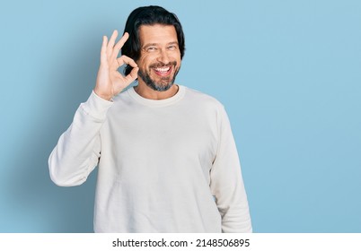 Middle age caucasian man wearing casual clothes smiling positive doing ok sign with hand and fingers. successful expression.  - Shutterstock ID 2148506895