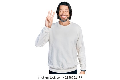 Middle age caucasian man wearing casual clothes showing and pointing up with fingers number three while smiling confident and happy.  - Shutterstock ID 2158731479