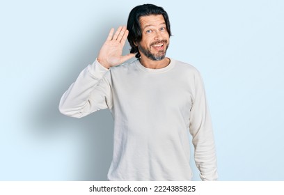 Middle age caucasian man wearing casual clothes waiving saying hello happy and smiling, friendly welcome gesture  - Shutterstock ID 2224385825