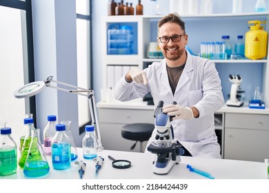 Middle Age Caucasian Man Working At Scientist Laboratory Smiling Happy Pointing With Hand And Finger 