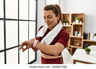 Middle Age Caucasian Sporty Woman Looking Watch At Home.