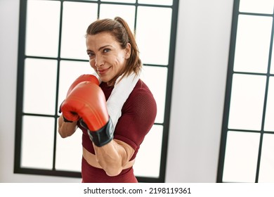 Middle age caucasian sporty woman boxing at home. - Powered by Shutterstock