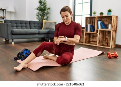 Middle Age Caucasian Sporty Woman Looking Watch At Home.