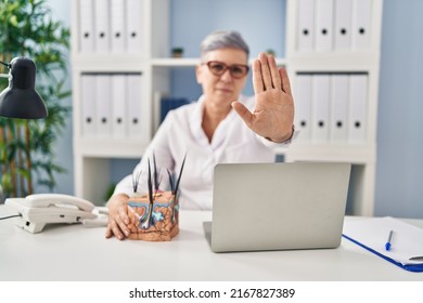 Middle Age Caucasian Woman Holding Model Of Human Anatomical Skin And Hair With Open Hand Doing Stop Sign With Serious And Confident Expression, Defense Gesture 