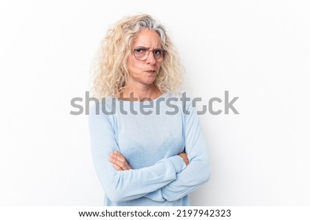 Middle age caucasian woman isolated on white background suspicious, uncertain, examining you.