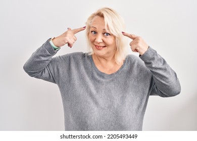 Middle Age Caucasian Woman Standing Over White Background Smiling Pointing To Head With Both Hands Finger, Great Idea Or Thought, Good Memory 