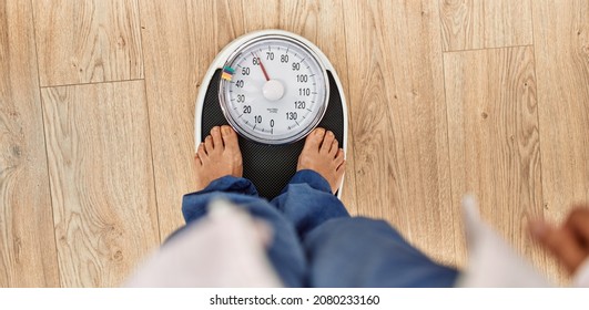 Middle age caucasian woman using weighing machine at home