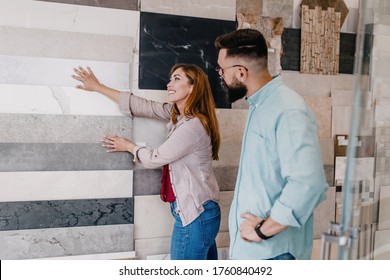 Middle Age Couple Choosing Accessories And Utensils For Their New Bathroom