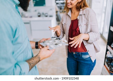 Middle Age Couple Choosing Ceramic Tiler For Their New Bathroom.