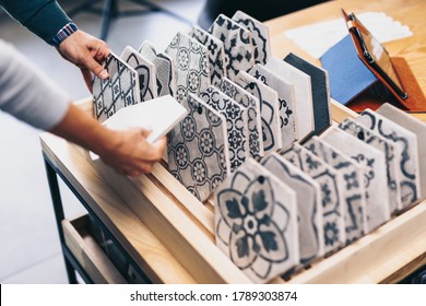 Middle Age Couple Choosing New Ceramic Tiles For Their Home Bathroom