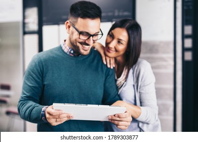 Middle Age Couple Choosing New Ceramic Tiles For Their Home Bathroom