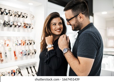 Middle Age Couple Enjoying In Shopping At Modern Jewelry Store. Close Up Shot Of Human Hand Holding Expensive Watch.