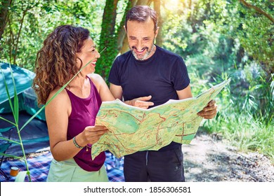 Middle Age Couple  Of Hiker Camping At The Forest. Standing With Smile On Face Looking At The Map.