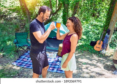 Middle Age Couple  Of Hiker Smiling Happy Drinking Coffee Camping At The Forest.