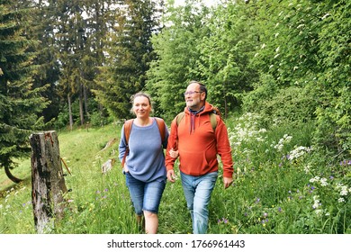 Middle Age Couple Hiking In Green Forest, Active Family Time