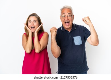 Middle age couple isolated on white background celebrating a victory - Powered by Shutterstock
