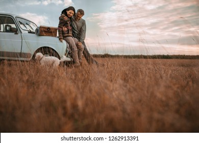 Middle Age Couple And Pet At Picnic