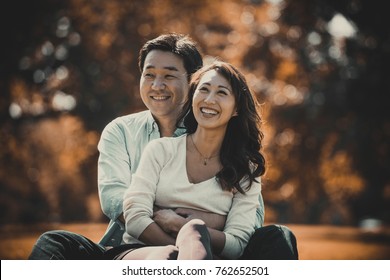 Middle Age Couple Spending Time Together In Tokyo On A Sunny Autumn Day