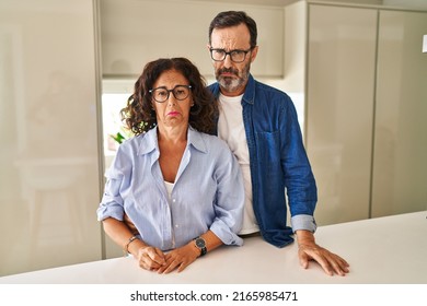 Middle Age Couple Standing Together Depressed And Worry For Distress, Crying Angry And Afraid. Sad Expression. 