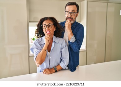 Middle Age Couple Standing Together Thinking Worried About A Question, Concerned And Nervous With Hand On Chin 