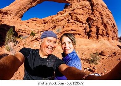 Middle Age Couple Taking A Selfie And Enjoying The Natural Beauty Of Arches National Park In Utah.