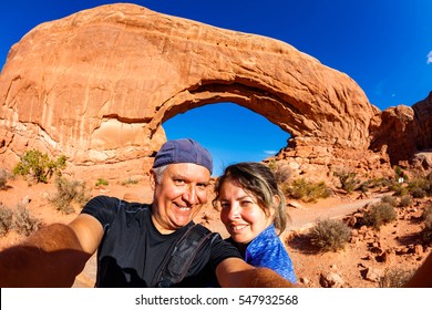 Middle Age Couple Taking A Selfie And Enjoying The Natural Beauty Of Arches National Park In Utah.