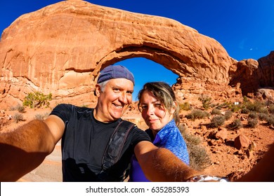 Middle Age Couple Taking A Selfie And Enjoying The Natural Beauty Of Arches National Park In Utah.