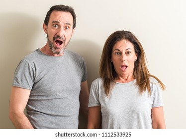 Middle Age Couple, Woman And Man Scared In Shock With A Surprise Face, Afraid And Excited With Fear Expression