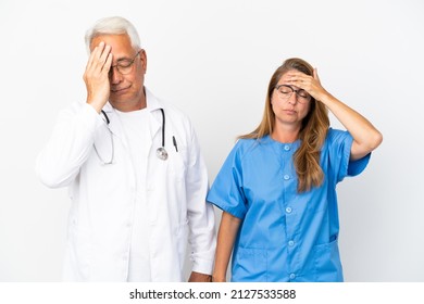 Middle Age Doctor And Nurse Isolated On White Background With Surprise And Shocked Facial Expression