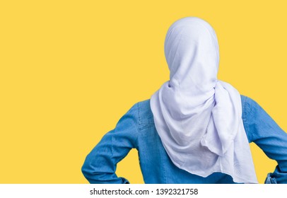 Middle Age Eastern Arab Woman Wearing Arabian Hijab Over Isolated Background Standing Backwards Looking Away With Arms On Body