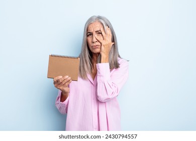 middle age gray hair woman feeling bored, frustrated and sleepy after a tiresome. 2022 calendar concept