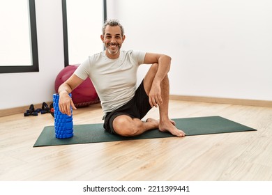 Middle Age Grey-haired Man Smiling Confident Leaning On Foam Roller At Sport Center