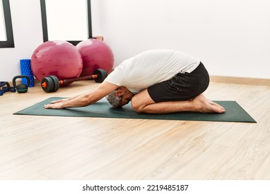 Middle Age Grey-haired Man Stretching Back At Sport Center