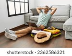 Middle age grey-haired man using laptop looking for travel at home