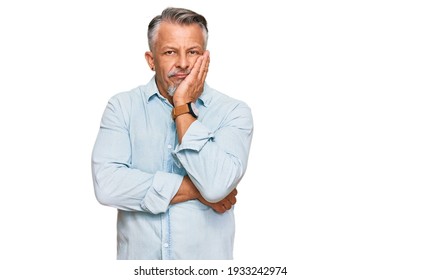 Middle age grey-haired man wearing casual clothes thinking looking tired and bored with depression problems with crossed arms.  - Shutterstock ID 1933242974
