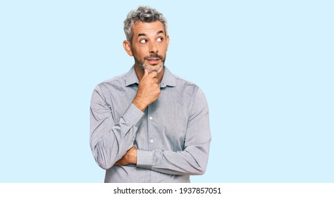 Middle age grey-haired man wearing casual clothes with hand on chin thinking about question, pensive expression. smiling with thoughtful face. doubt concept.  - Powered by Shutterstock