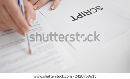 Middle age grey-haired woman reading movie script on table