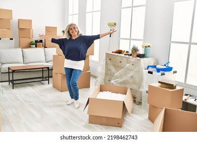 Middle Age Grey-haired Woman Smiling Happy Dancing At New Home.