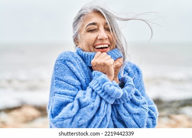 Middle age grey-haired woman smiling confident standing at seaside - Powered by Shutterstock