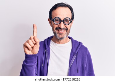 Middle Age Handsome Freaky Man Wearing Dumb Glasses Over Isolated White Background Smiling With An Idea Or Question Pointing Finger Up With Happy Face, Number One