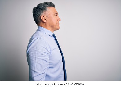 Middle Age Handsome Grey-haired Business Man Wearing Elegant Shirt And Tie Looking To Side, Relax Profile Pose With Natural Face And Confident Smile.