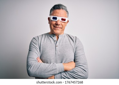 Middle age handsome grey-haired man using 3d glasses over isolated white background happy face smiling with crossed arms looking at the camera. Positive person.
