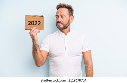 Middle Age Handsome Man Feeling Sad, Upset Or Angry And Looking To The Side. 2022 Calendar Concept