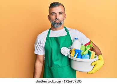 Middle Age Handsome Man Holding Cleaning Products Thinking Attitude And Sober Expression Looking Self Confident 