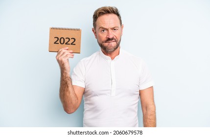 Middle Age Handsome Man Looking Puzzled And Confused. 2022 Calendar Concept